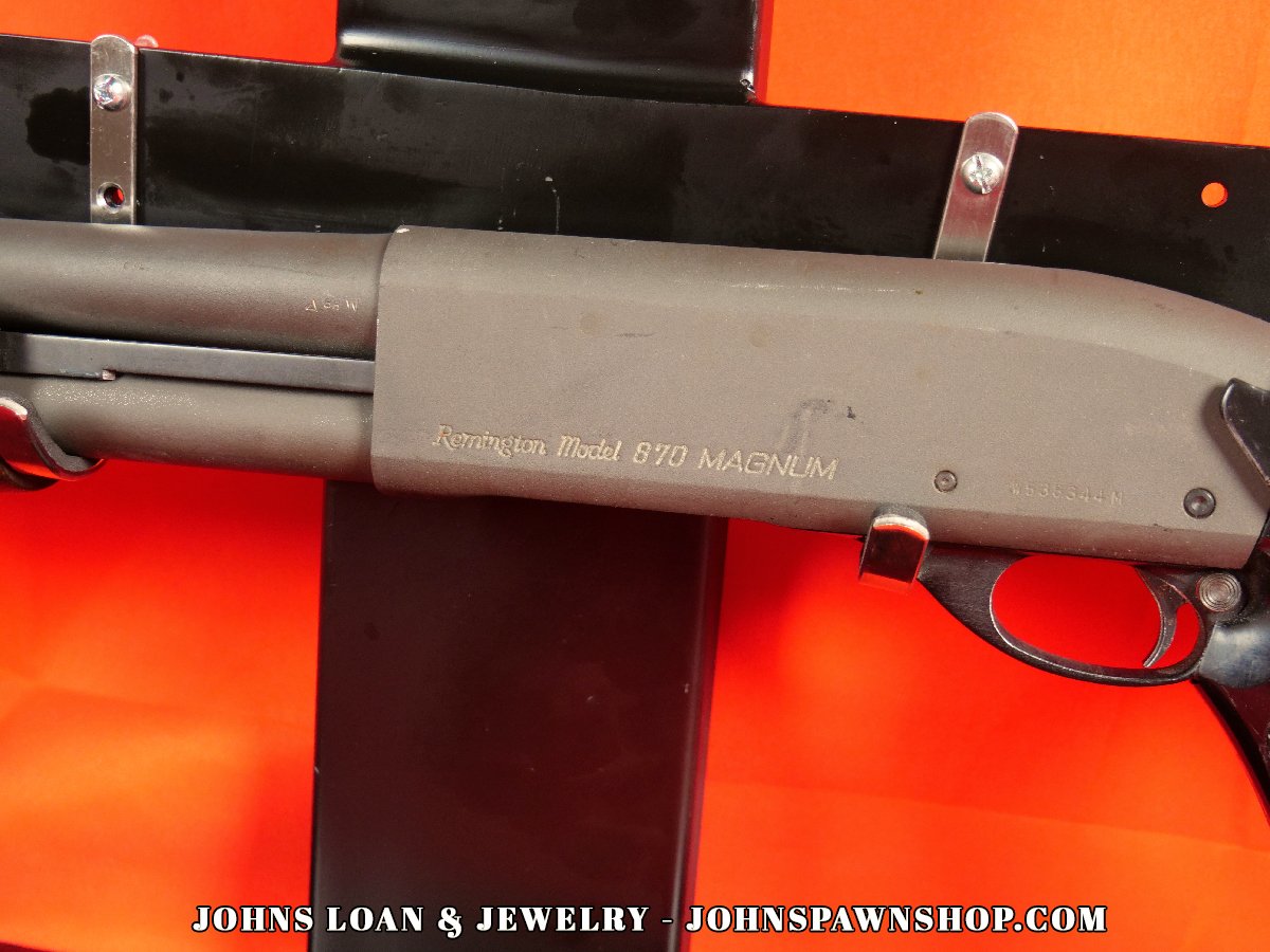 Close-up of the Remington 870 Magnum receiver, engraved with model information, and showcasing matte finish, available at John's Loan & Jewelry for law enforcement.