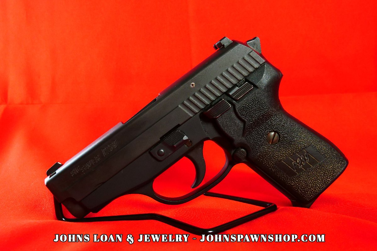The German-made Sig Sauer P239 semi auto pistol in 9mm, displayed on a table at John's Loan & Jewelry, a Las Vegas pawn shop firearm.