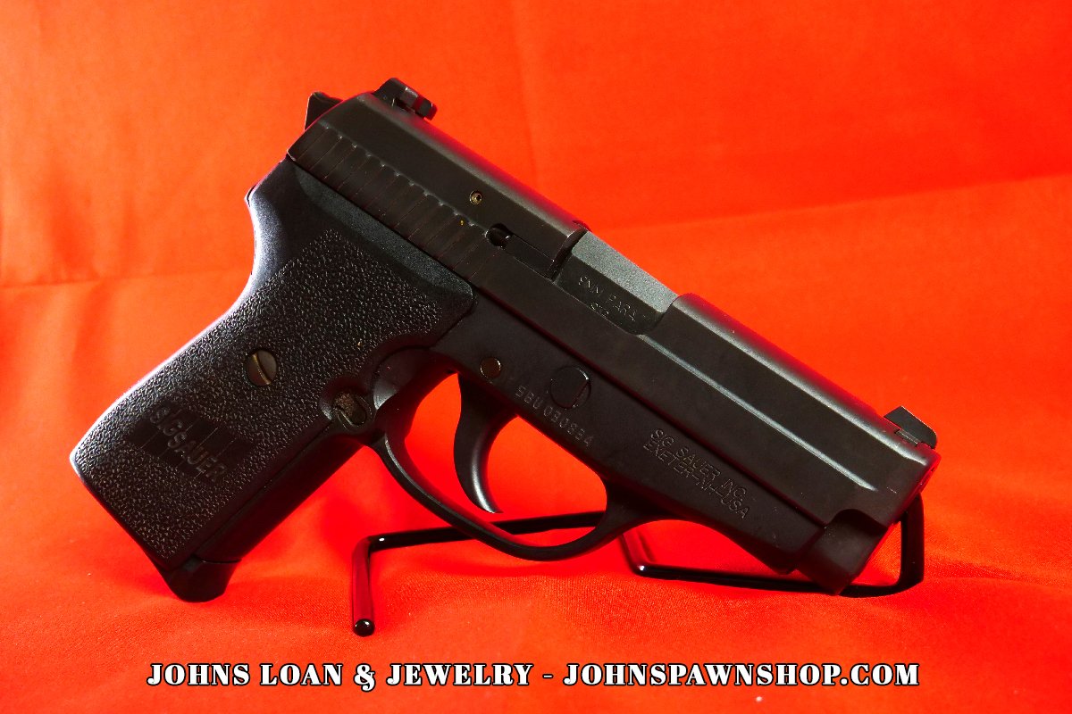German-made Sig Sauer P239 semi auto pistol displayed from a side angle on a table at John's Loan & Jewelry, Las Vegas pawn shop.