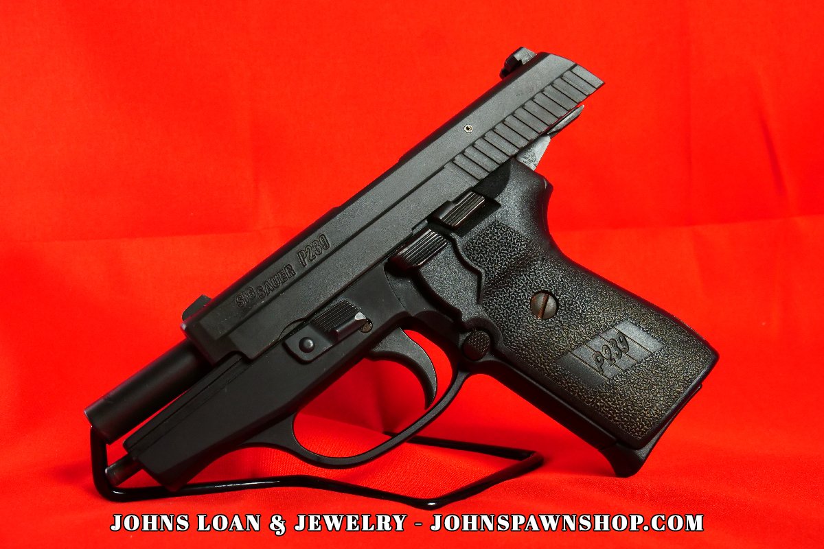 Sig Sauer P239 semi auto pistol on display, featuring the textured grip and sleek design, available at John's Loan & Jewelry.
