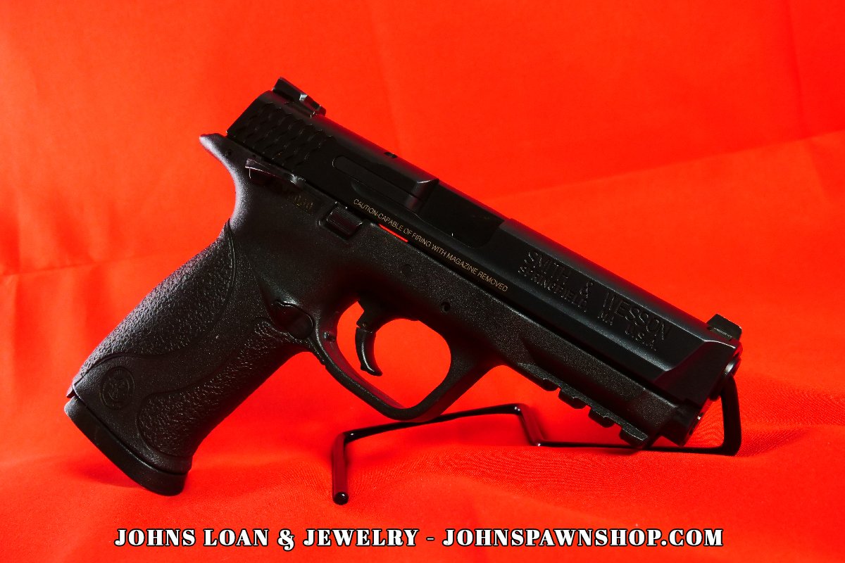 Smith & Wesson Military & Police 9mm semi-auto pistol on display, featuring the textured grip and sleek design, available at John's Loan & Jewelry.