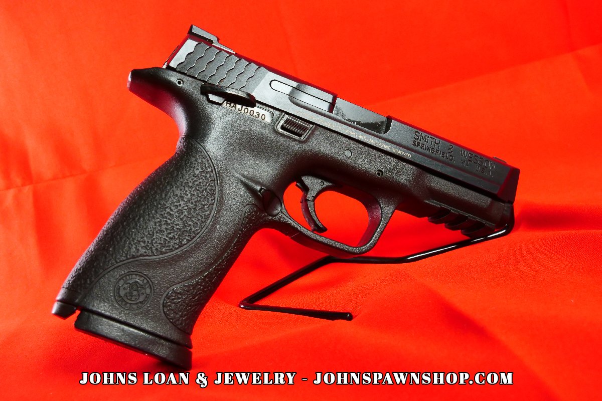 Smith & Wesson Military & Police 9mm semi-auto pistol on display, featuring the textured grip and sleek design, available at John's Loan & Jewelry.