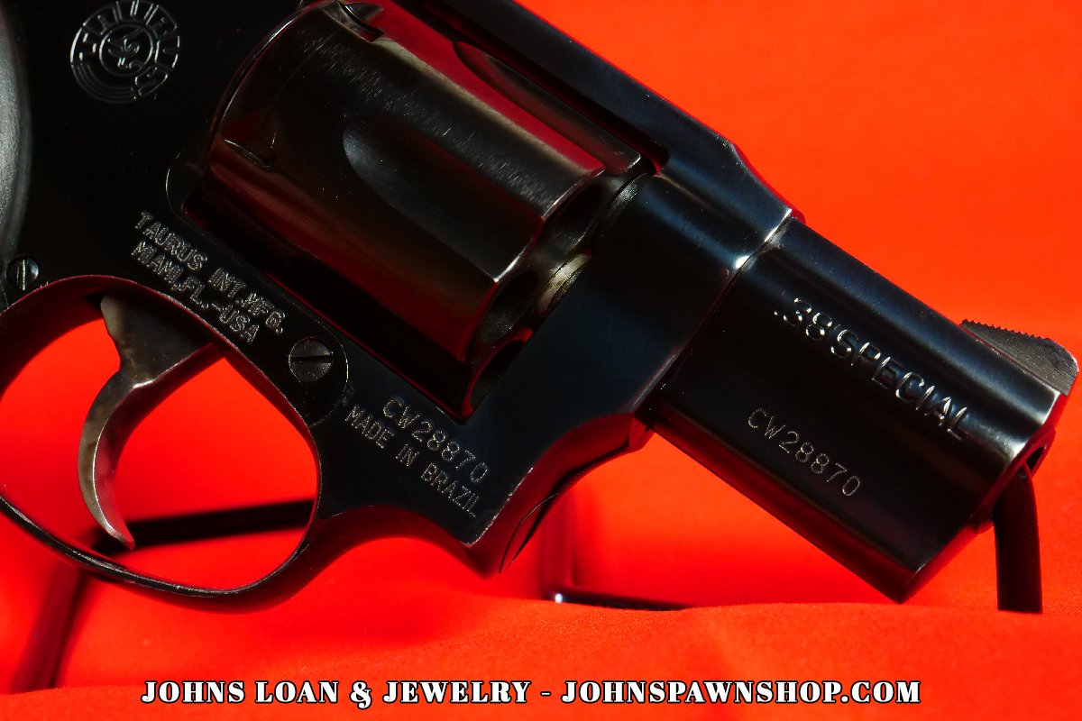 Close-up detail of the .38 Special marking on a Taurus Model 85 snub nose revolver firearm, showcasing the trigger and serial number, from John's Loan & Jewelry.